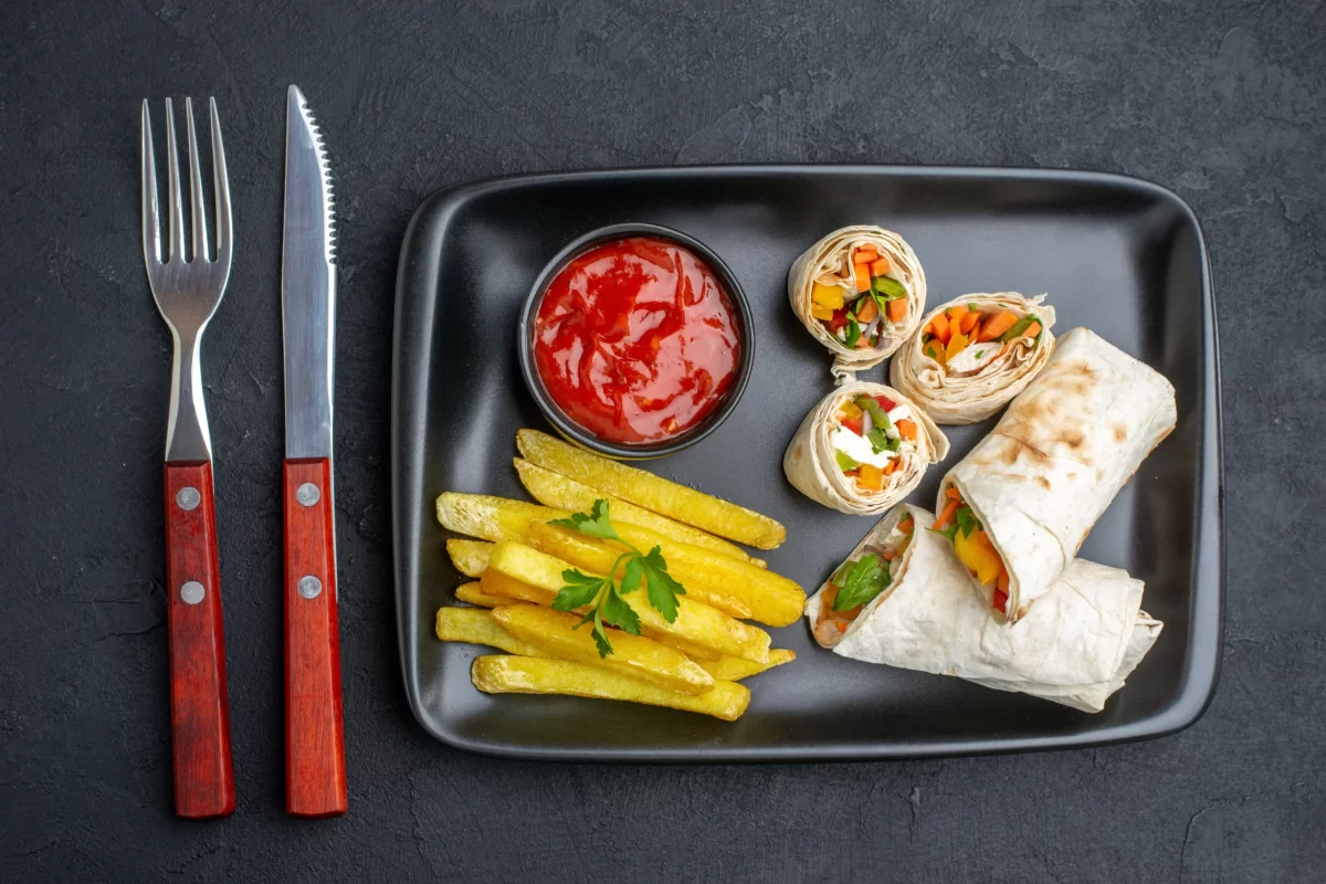 top-view-tasty-shaurma-sliced-pita-sandwich-with-french-fries-ketchup-dark-surface-burger-food-fast-food-meal-grill-bread-snack-toasts